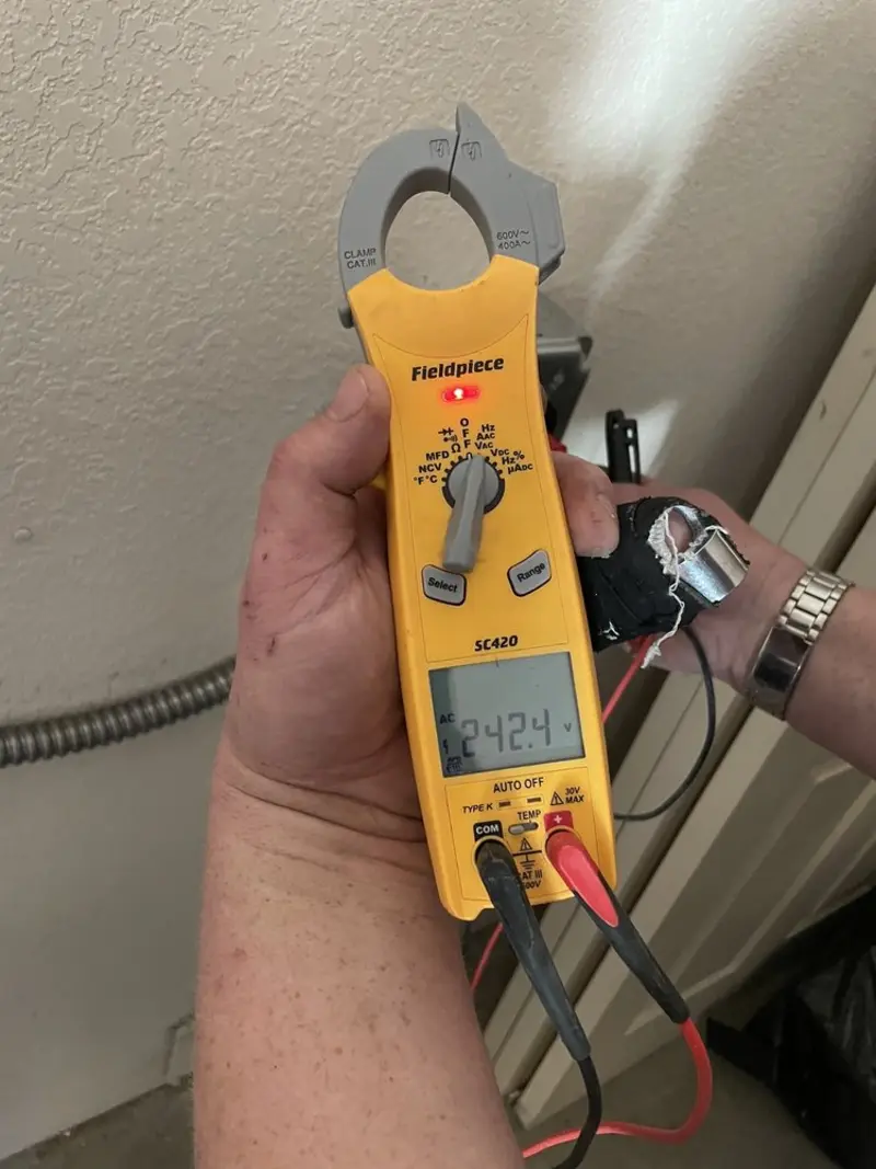 Voltage testing with clamp meter during Ceiling Fan Installation in Manchester
